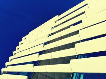 Low angle view of building against clear blue sky