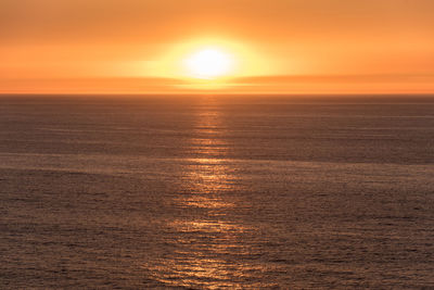 Scenic view of sea against orange sky