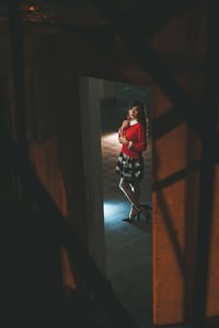 Girl looking through window