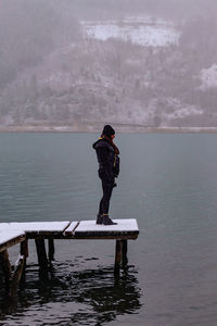 Rear view of man standing in sea