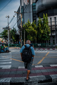 Rear view of man walking on street