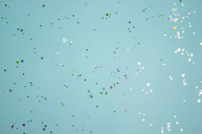 Low angle view of balloons against blue sky