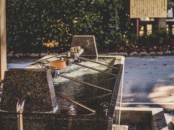 Water fountain on table against trees