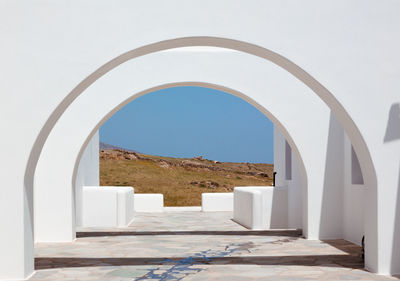 Corridor of building against clear blue sky