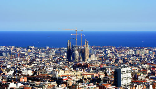 High angle view of buildings by sea against sky