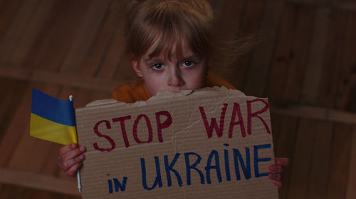 High angle view of young woman with text on table