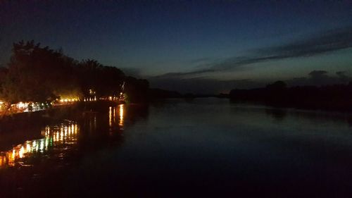 Scenic view of lake against sky at dusk