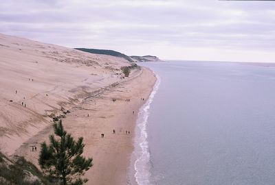 View of beach against cloudy sky