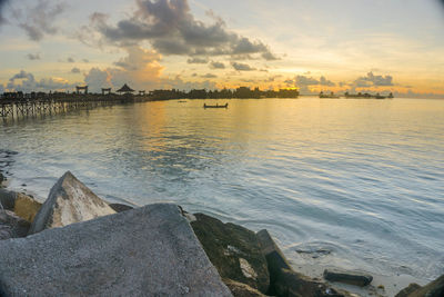 View of boats in sea at sunset