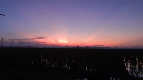 Scenic view of silhouette landscape against romantic sky at sunset