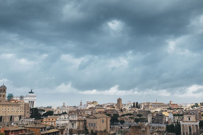 Buildings against cloudy sky