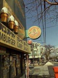 Low angle view of text on building against sky