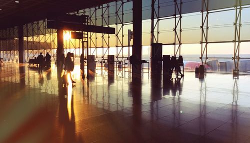 Silhouette people in water against sky