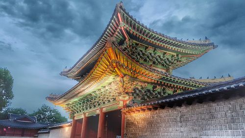 Low angle view of temple against cloudy sky