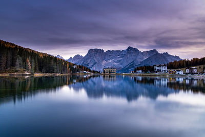 Scenic view of lake and mountains against sky during winter