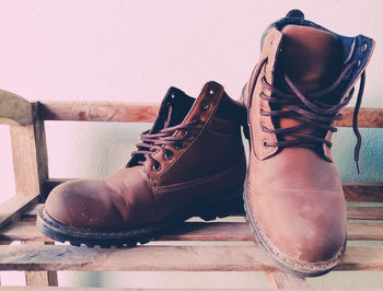 Close-up of shoes on floor against wall