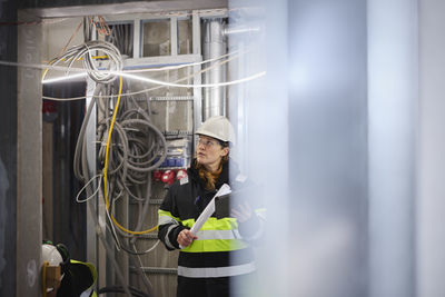 Female engineer using digital tablet at building site