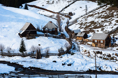 Houses on snow covered landscape during winter