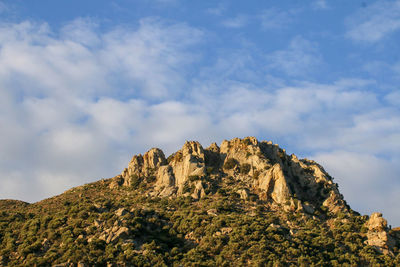 Low angle view of rock formation against sky