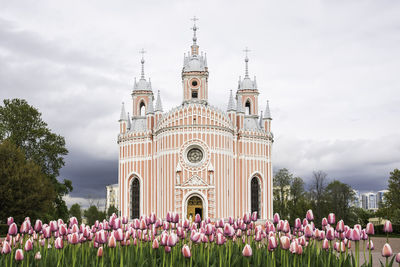 View of purple bell tower against cloudy sky