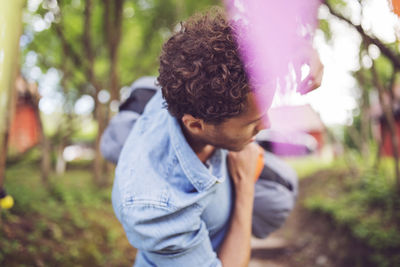 High angle view of man carrying bag at back yard