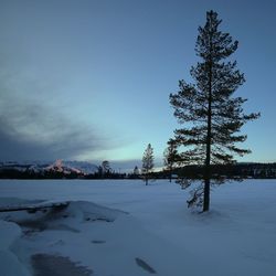 Scenic view of frozen lake against sky during winter