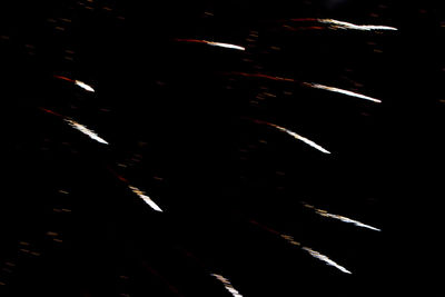 Aerial view of firework display over black background
