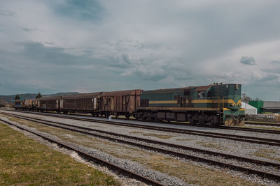 Train on railroad track against sky