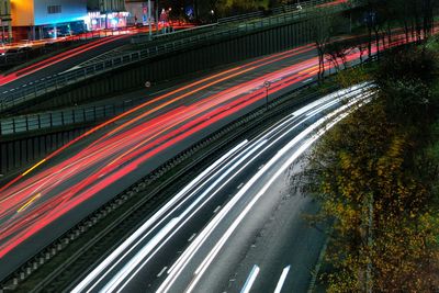 High angle view of light trails on road at night