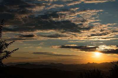 Scenic view of silhouette mountains against sky at sunset