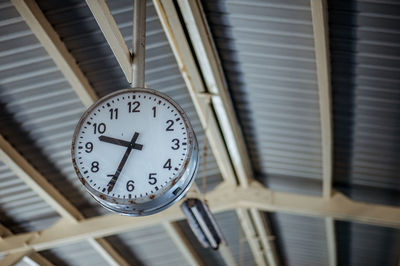 Low angle view of clock on ceiling