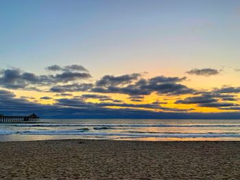 Scenic view of beach against sky during sunset