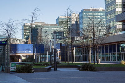 Street by buildings against sky in city