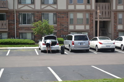 Cars on road by buildings in city