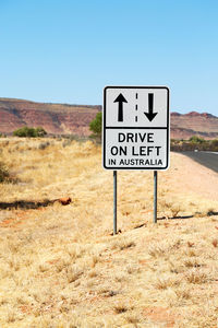 Information sign on road against clear sky