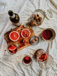 High angle view of fruits and wine bottle served on table