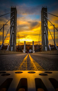 Suspension bridge against sky during sunset