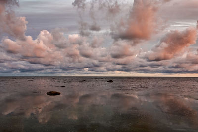 Scenic view of beach against sky during sunset