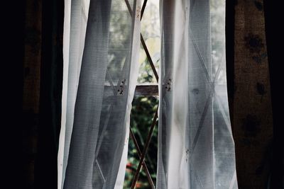 Close-up of curtain against window at home