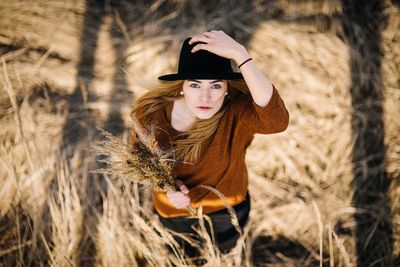 Portrait of woman standing on field