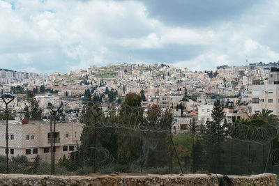 Buildings in town against sky