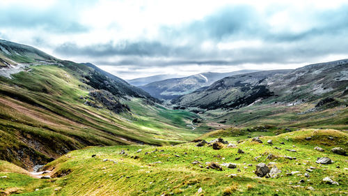 Scenic view of mountains against cloudy sky