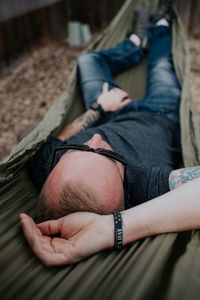 Man relaxing in hammock outside