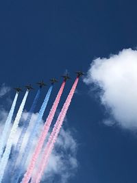 Low angle view of airplane flying against blue sky