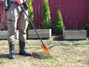 Low section of man standing on field