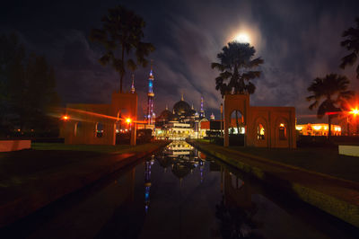 Illuminated temple against sky at night