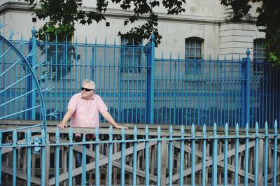 Man standing by fence