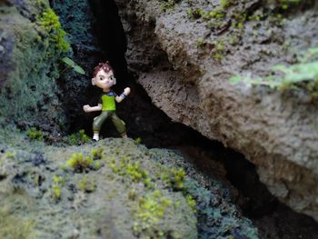 High angle view of figurine on rock
