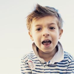 Portrait of cute boy against white background