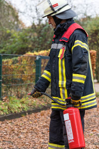 Man working with umbrella standing in background